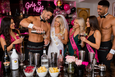 Two Buff Butlers serving drinks and entertaining guests during a hen party cocktail-making event.