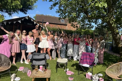 Hens posing for a group photo with Butlers in the Buff hosts at a hen party
